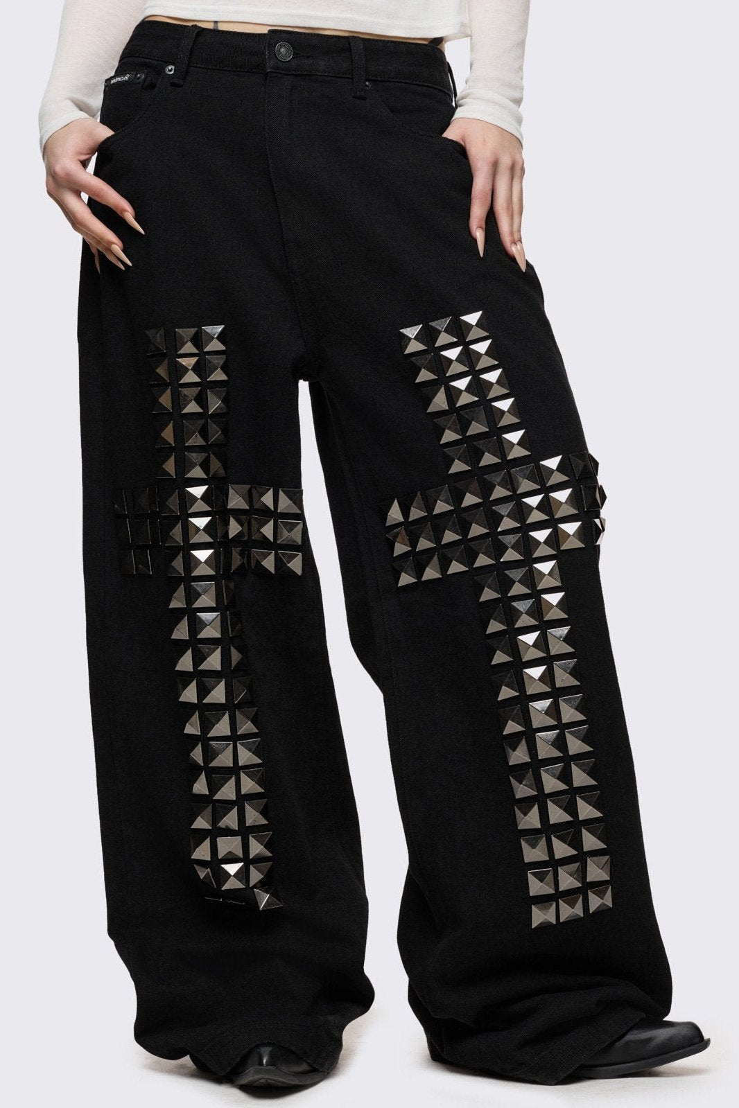 Black baggy jeans with silver studded crosses.