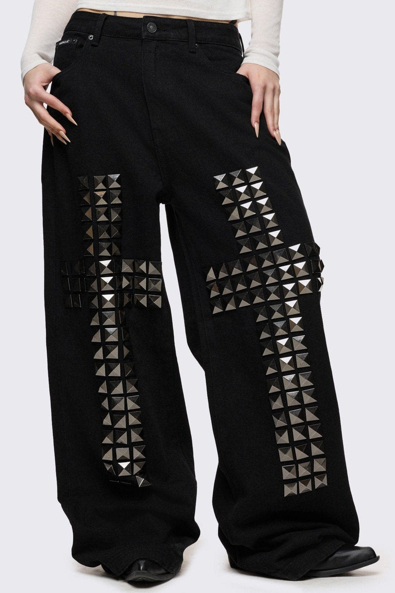 Black baggy jeans with silver studded crosses.