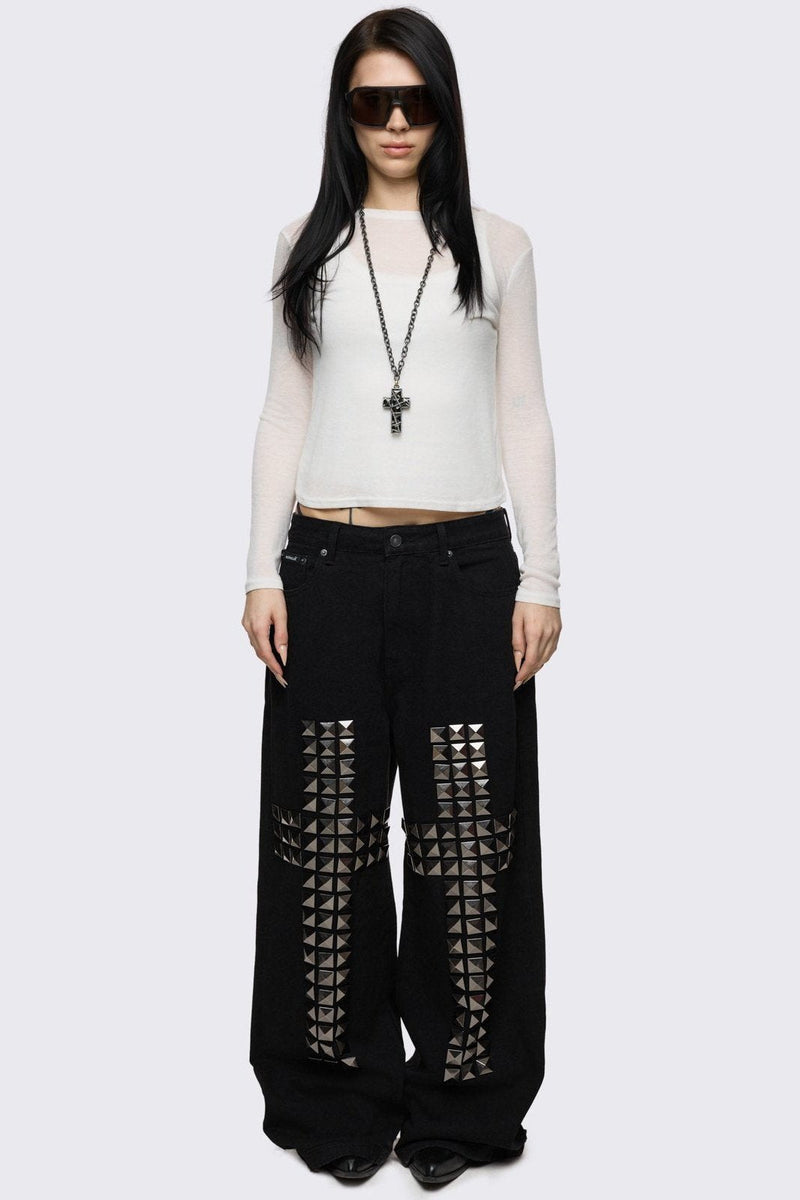 Black baggy jeans with silver studded crosses.