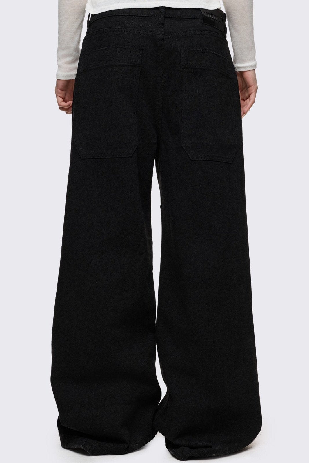 Black baggy jeans with silver studded crosses.