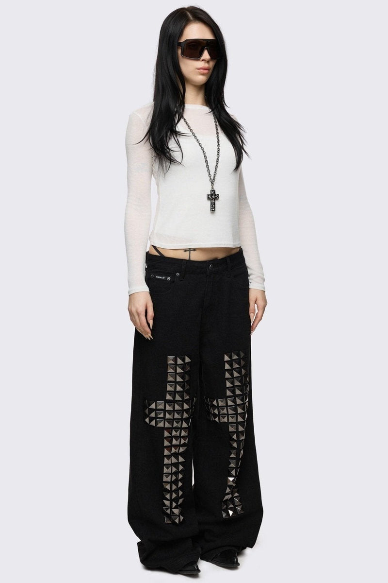 Black baggy jeans with silver studded crosses.