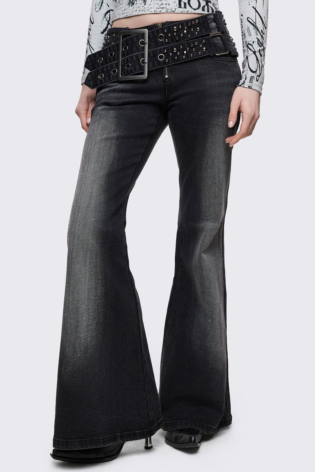 Grey washed flared jeans with double-buckle belt.