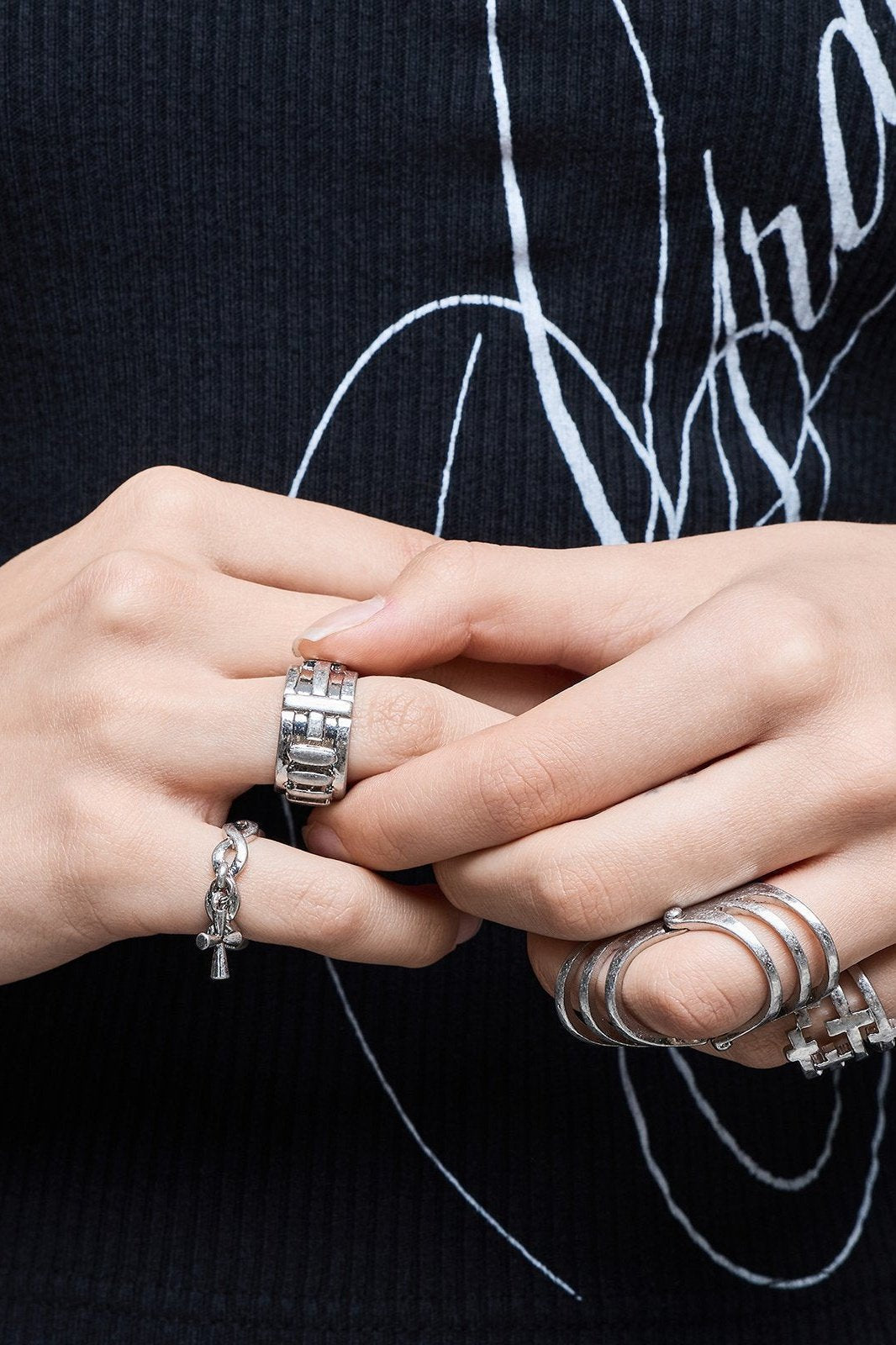 Silver set of 4 rings with cross designs.