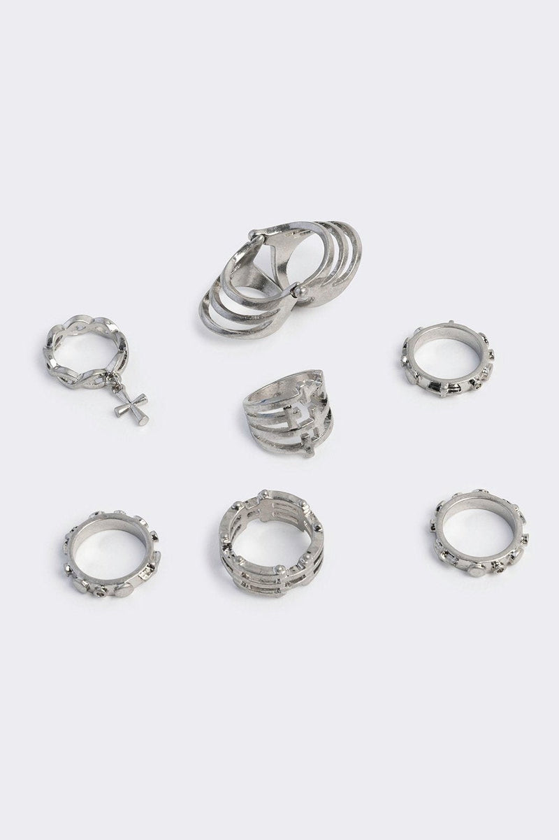 Silver set of 4 rings with cross designs.