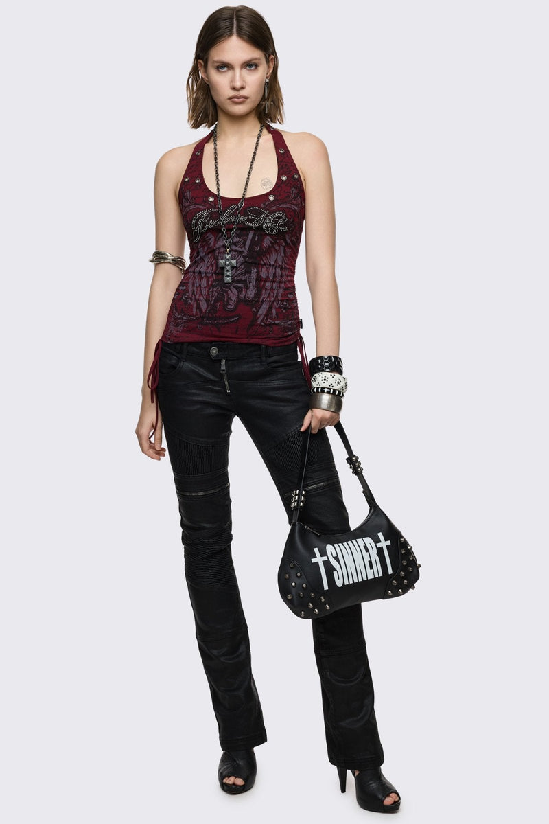 Black faux leather shoulder bag with white sinner cross print, studded panels and grunge aesthetic.