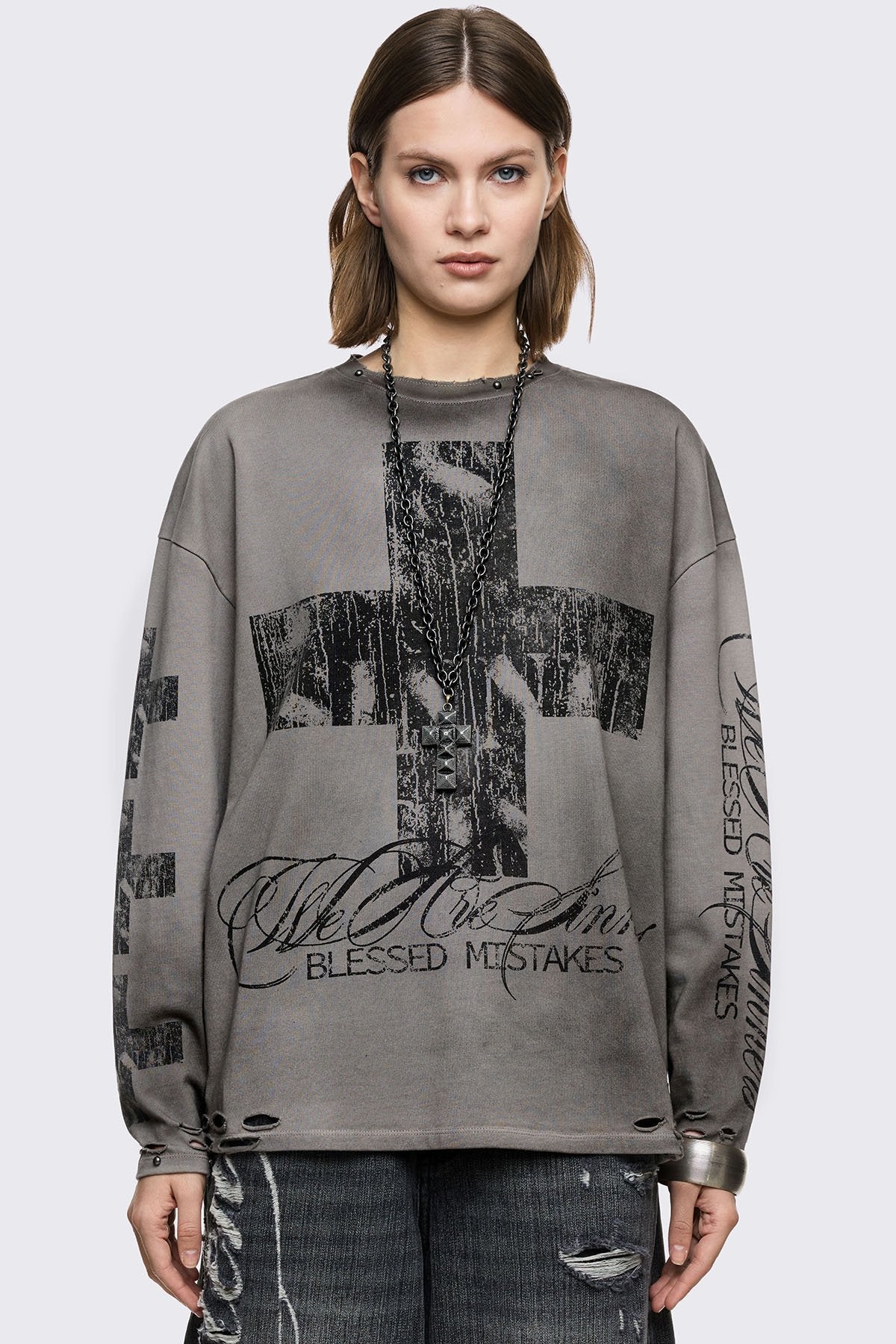 Grey cotton long sleeve T-shirt with cross graphic, studs and distressed hem in a grunge goth style.
