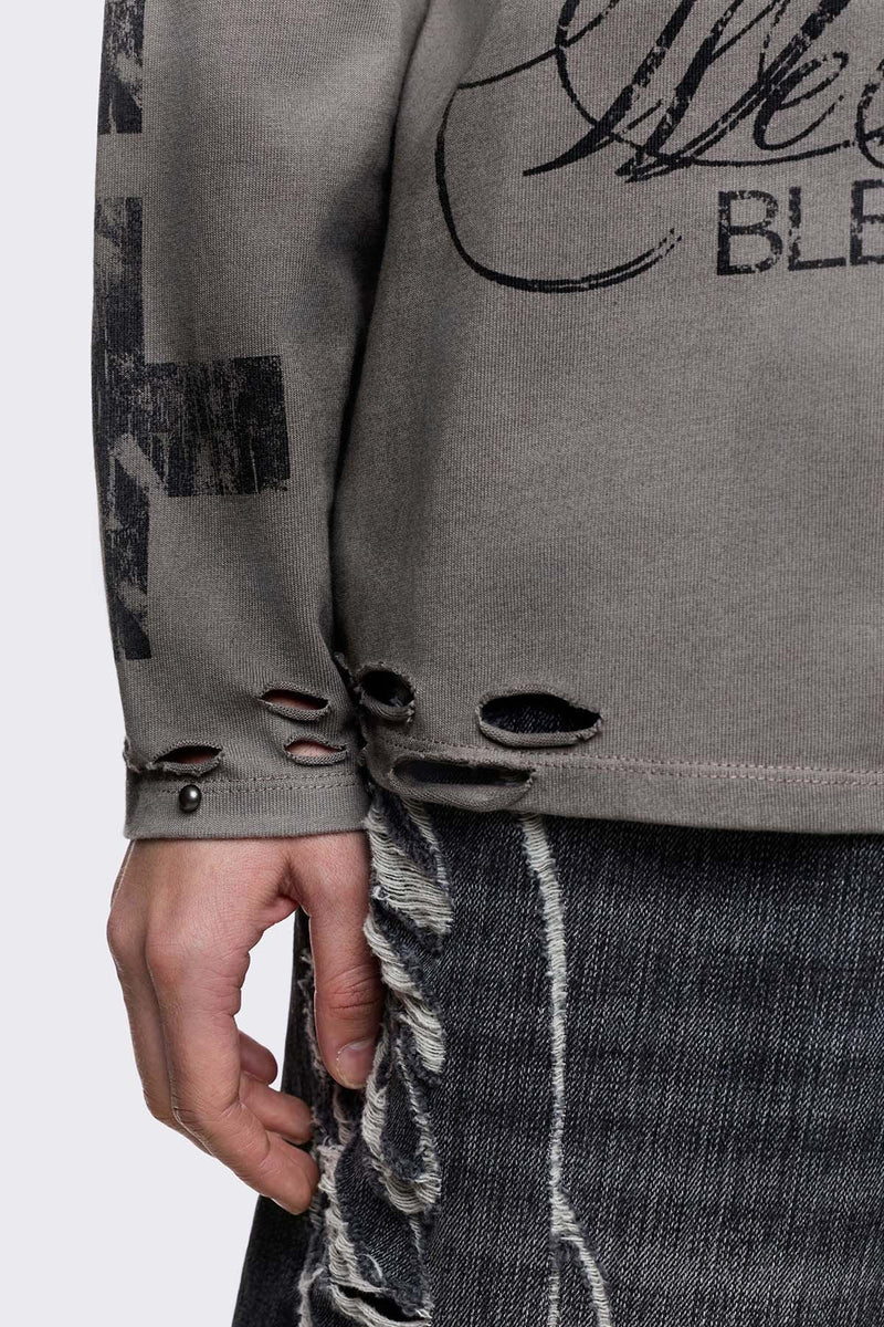 Grey cotton long sleeve T-shirt with cross graphic, studs and distressed hem in a grunge goth style.