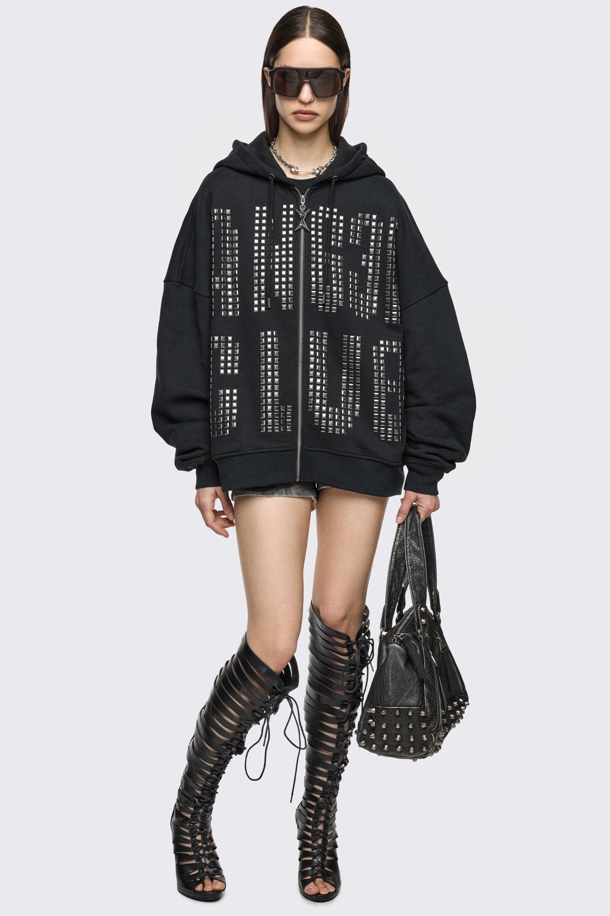 Black cotton zip-up hoodie with studded Angel Club design, oversized fit and grunge streetwear vibe.
