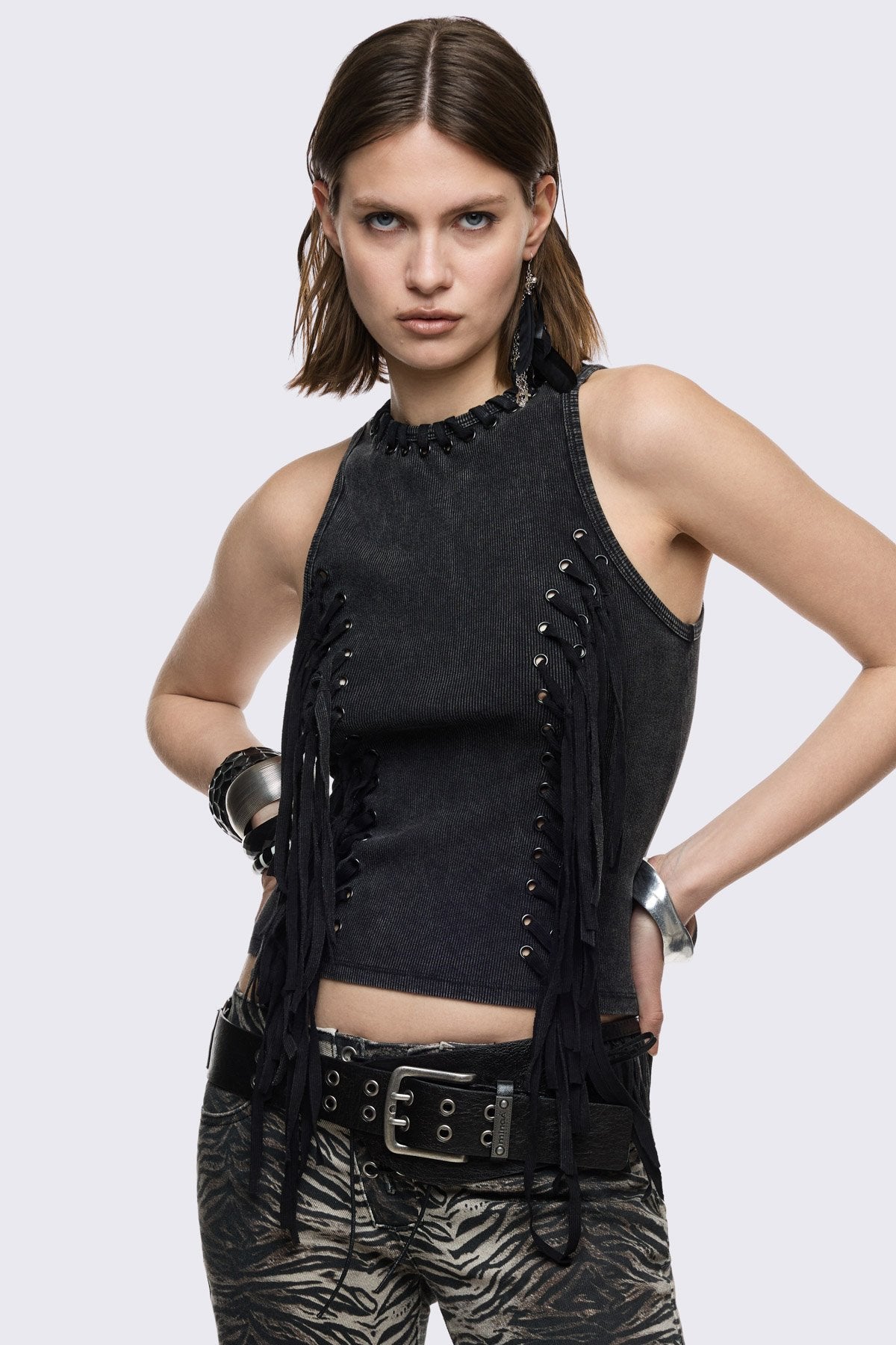 Black washed ribbed cotton tank top with lace-up eyelets and long hanging ties, slim grunge aesthetic.