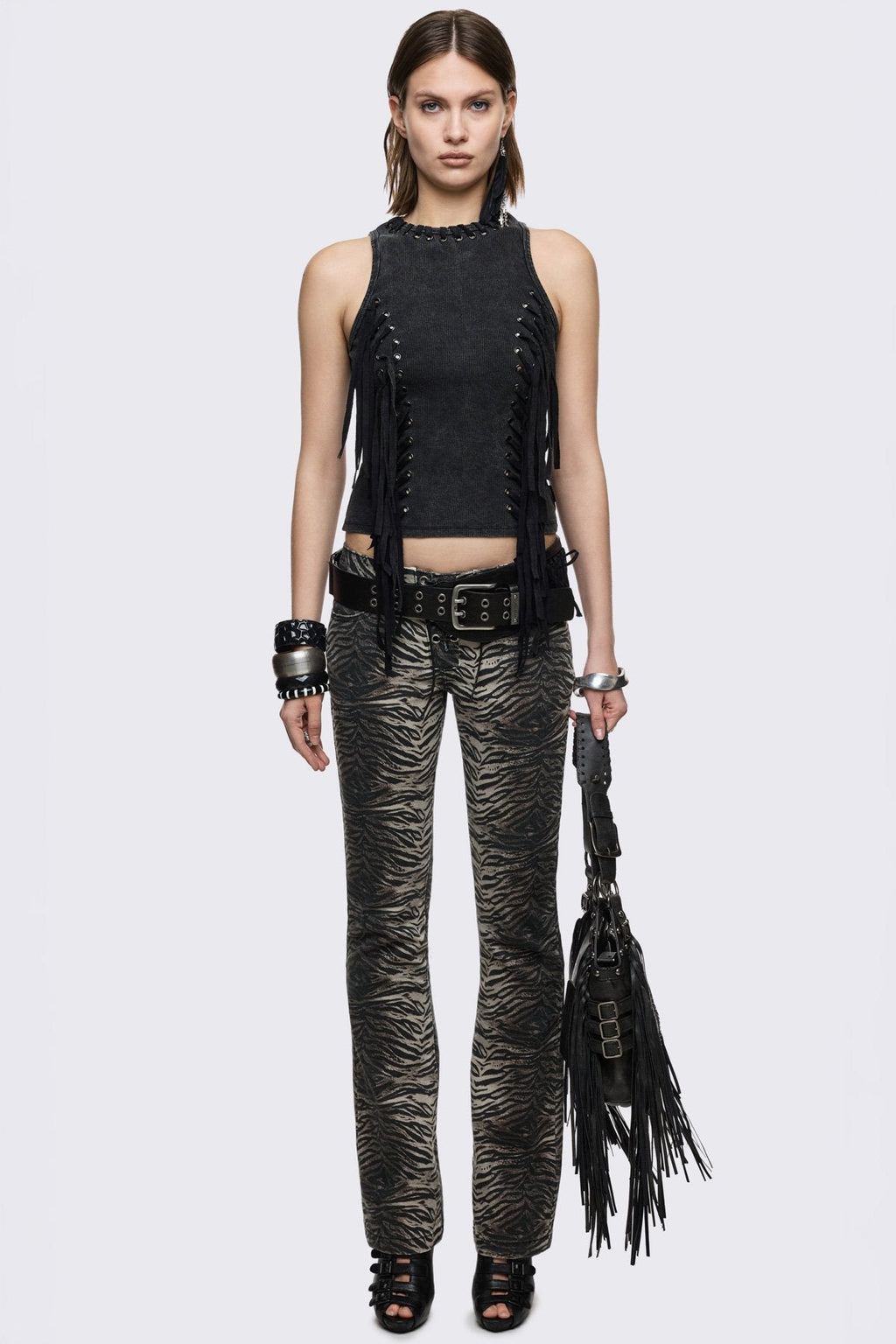 Black washed ribbed cotton tank top with lace-up eyelets and long hanging ties, slim grunge aesthetic.