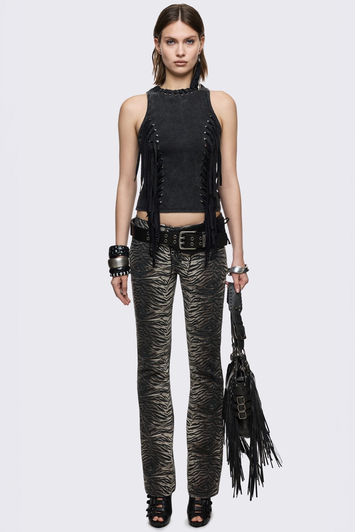 Black washed ribbed cotton tank top with lace-up eyelets and long hanging ties, slim grunge aesthetic.