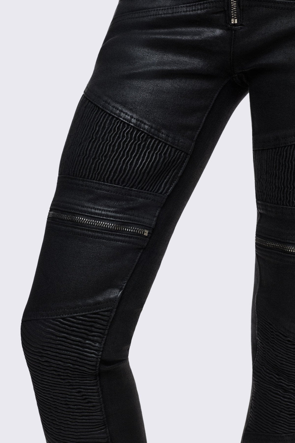 Bootcut jeans in black coated denim with ribbed paneling and zipper details, low-rise grunge aesthetic.