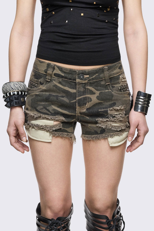 Camo micro shorts in stretch cotton with shredded details, exposed pockets, silver studs and raw hems, grunge vibe.