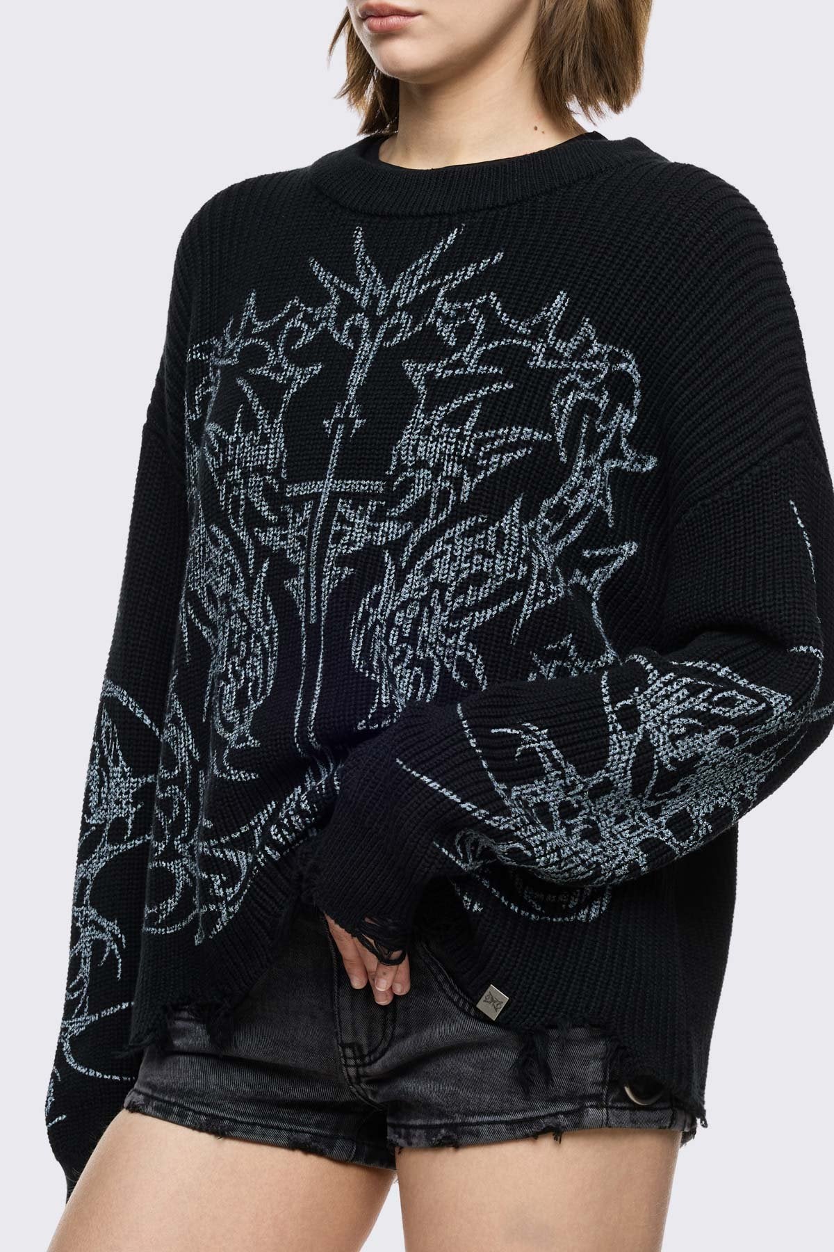 Black knitted jumper with cross sigilism graphic design and distressed rib 