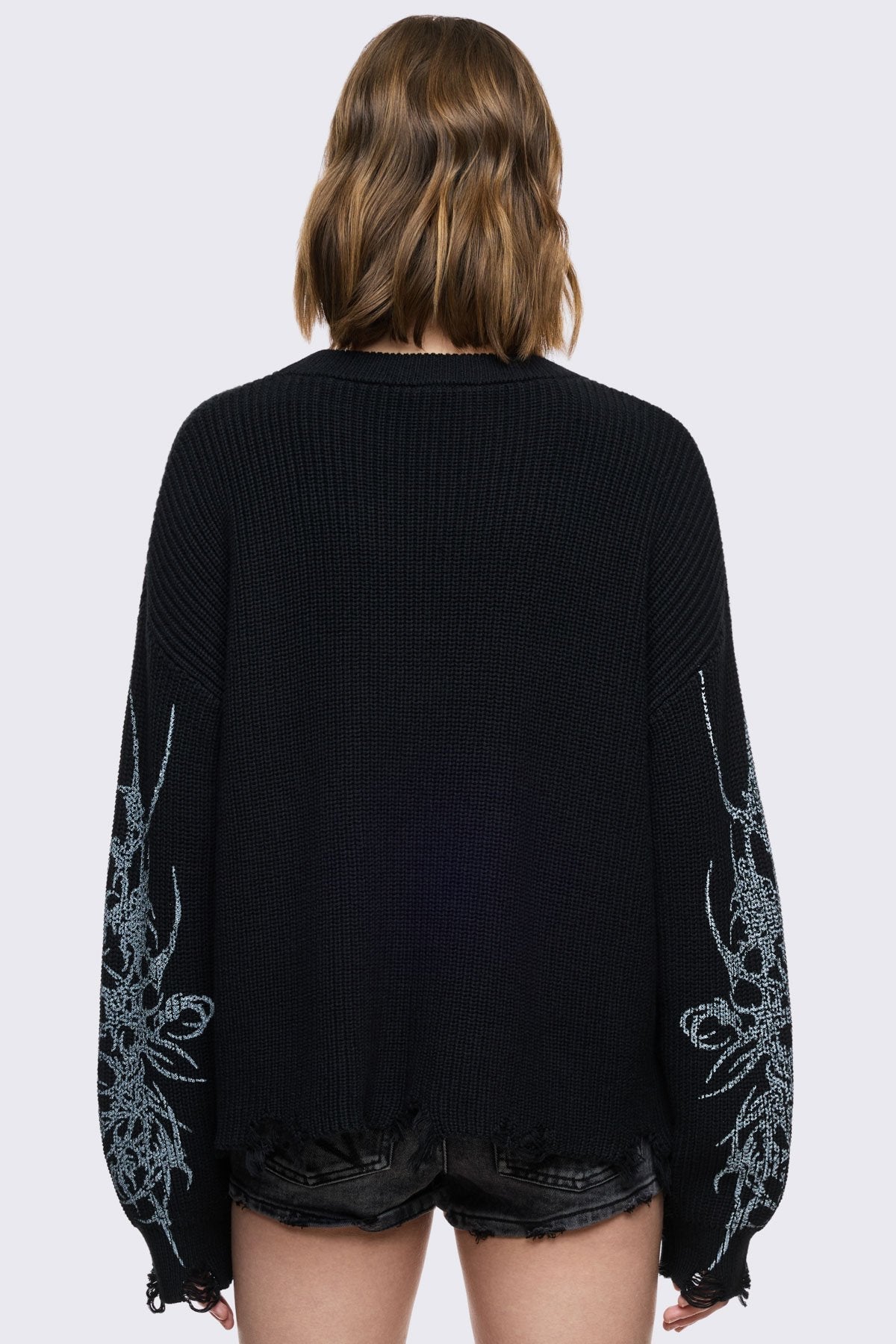 Black knitted jumper with cross sigilism graphic design and distressed rib 