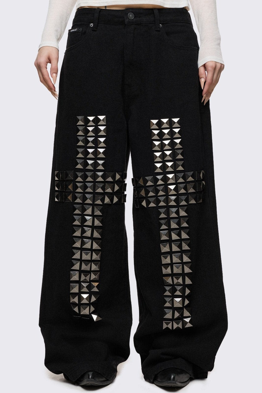 Black baggy jeans with silver studded crosses.