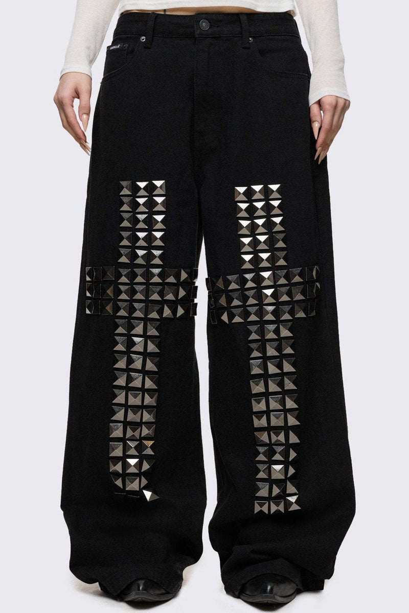 Black baggy jeans with silver studded crosses.