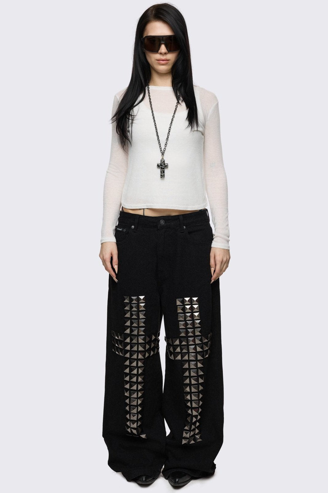 Black baggy jeans with silver studded crosses.