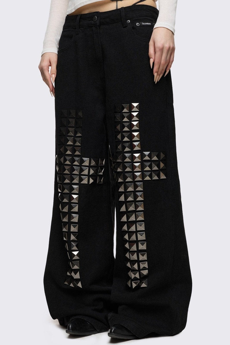 Black baggy jeans with silver studded crosses.