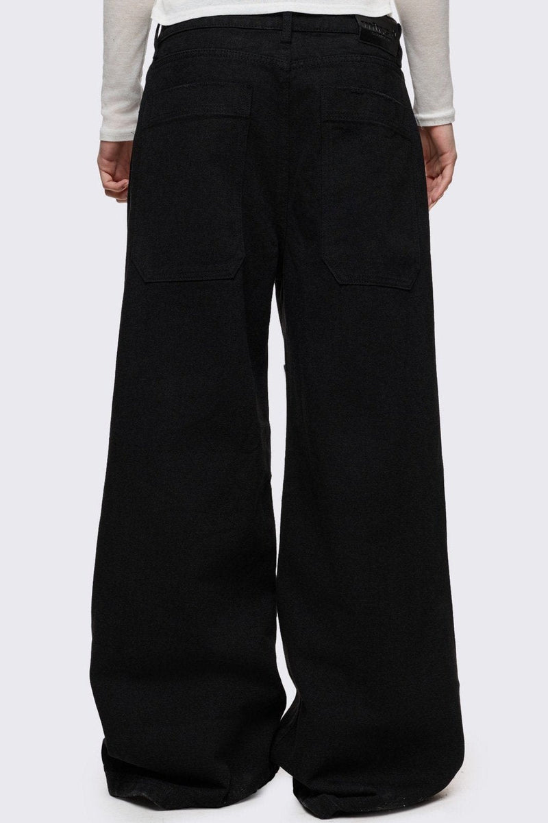 Black baggy jeans with silver studded crosses.