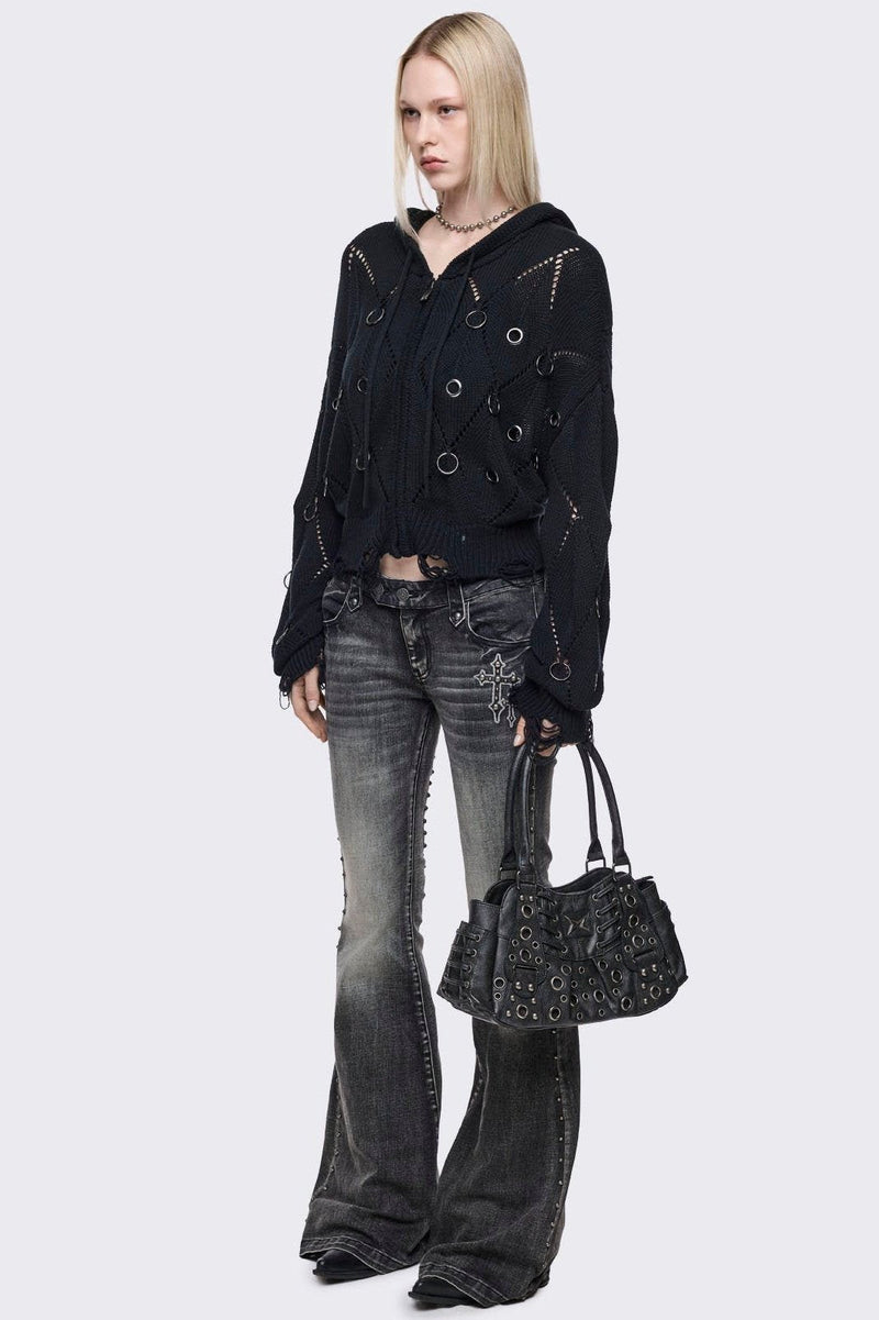 Black vegan leather shoulder bag with silver eyelets and multiple pockets