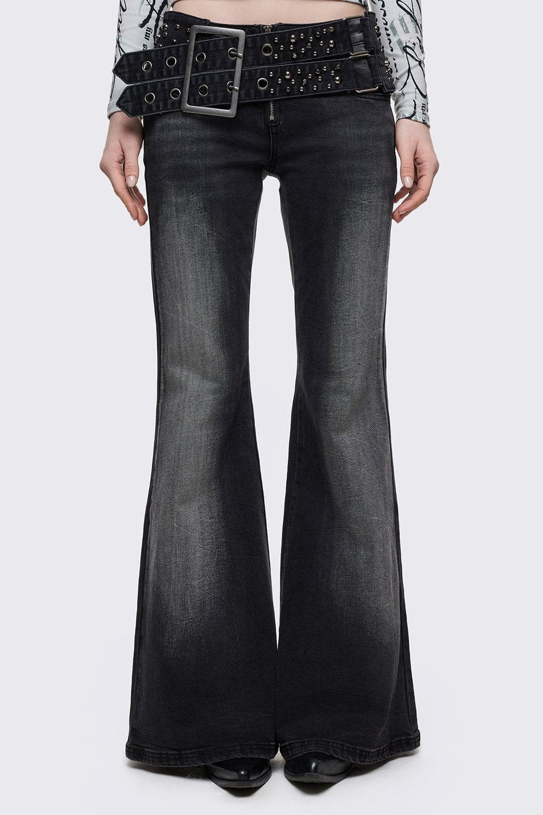 Grey washed flared jeans with double-buckle belt. 