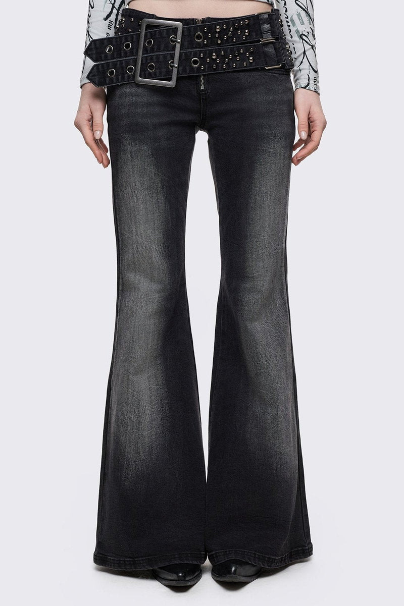 Grey washed flared jeans with double-buckle belt. 