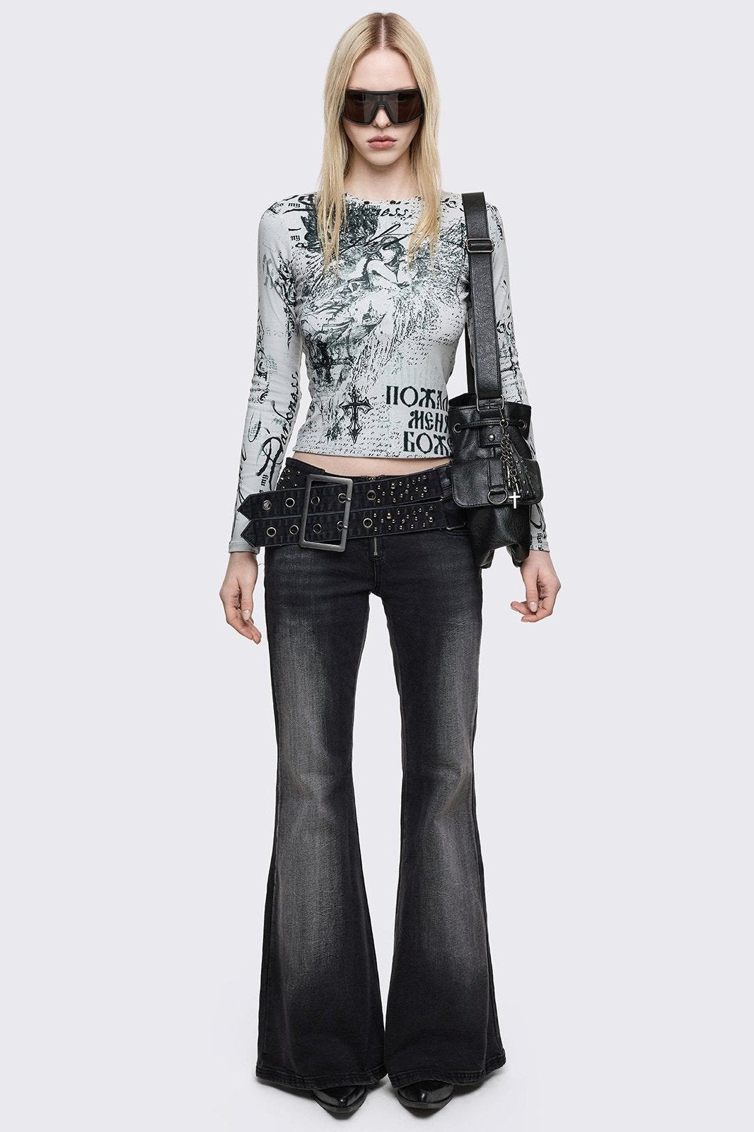 Grey washed flared jeans with double-buckle belt. 