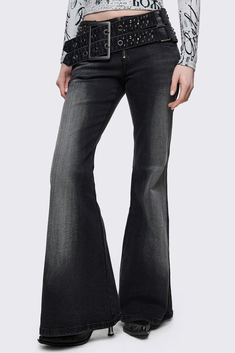 Grey washed flared jeans with double-buckle belt. 