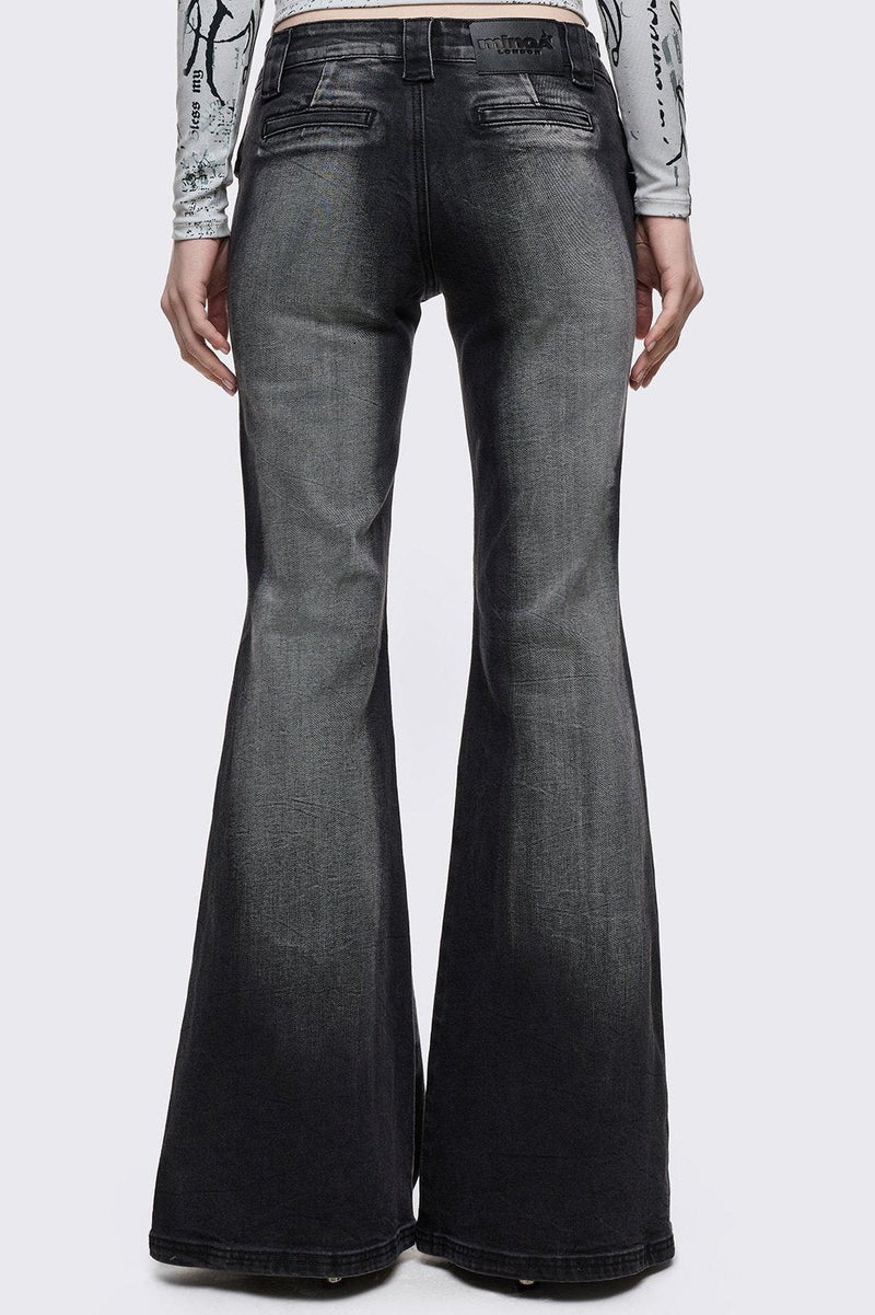 Grey washed flared jeans with double-buckle belt. 