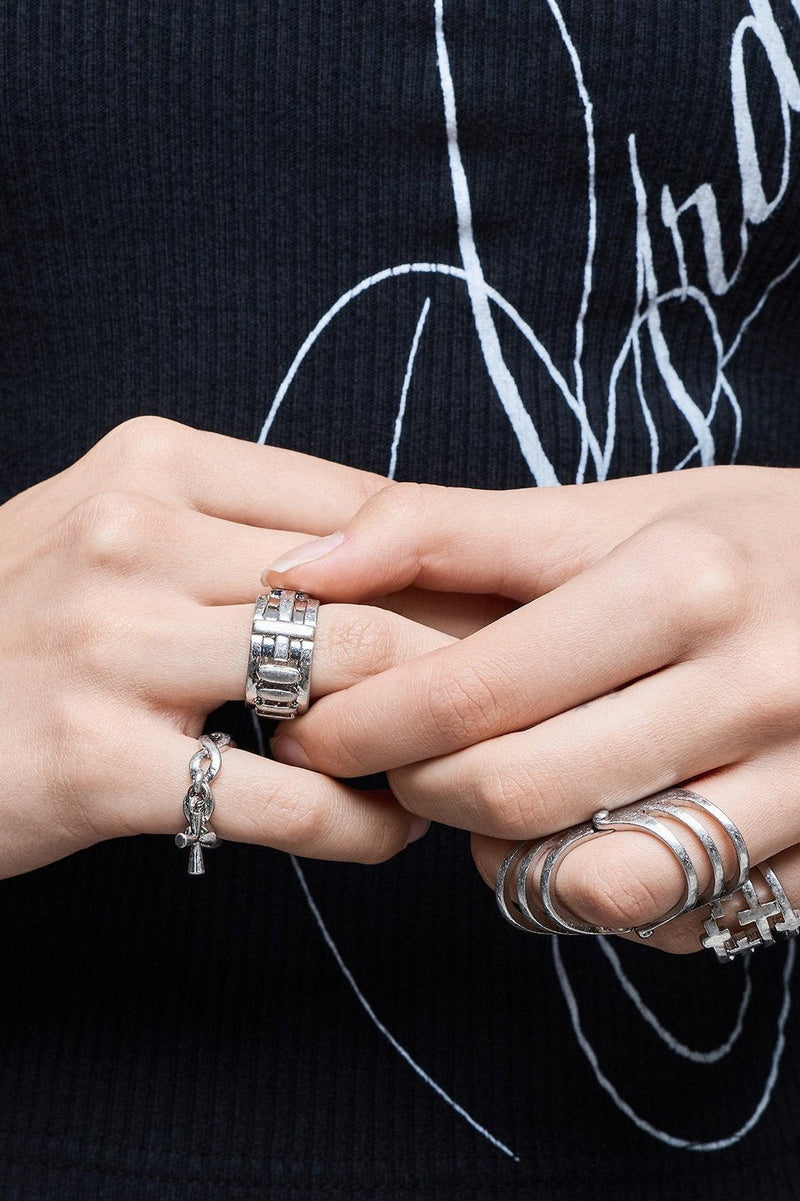 Silver set of 4 rings with cross designs.