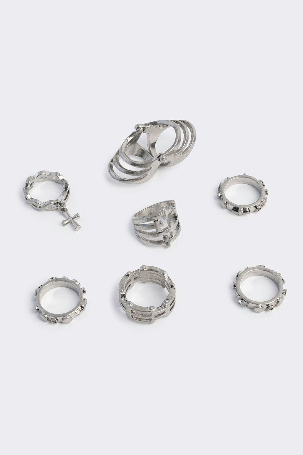 Silver set of 4 rings with cross designs.