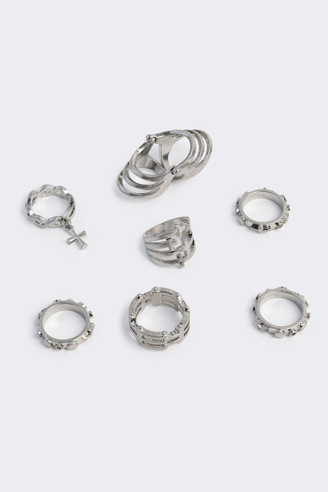 Silver set of 4 rings with cross designs.