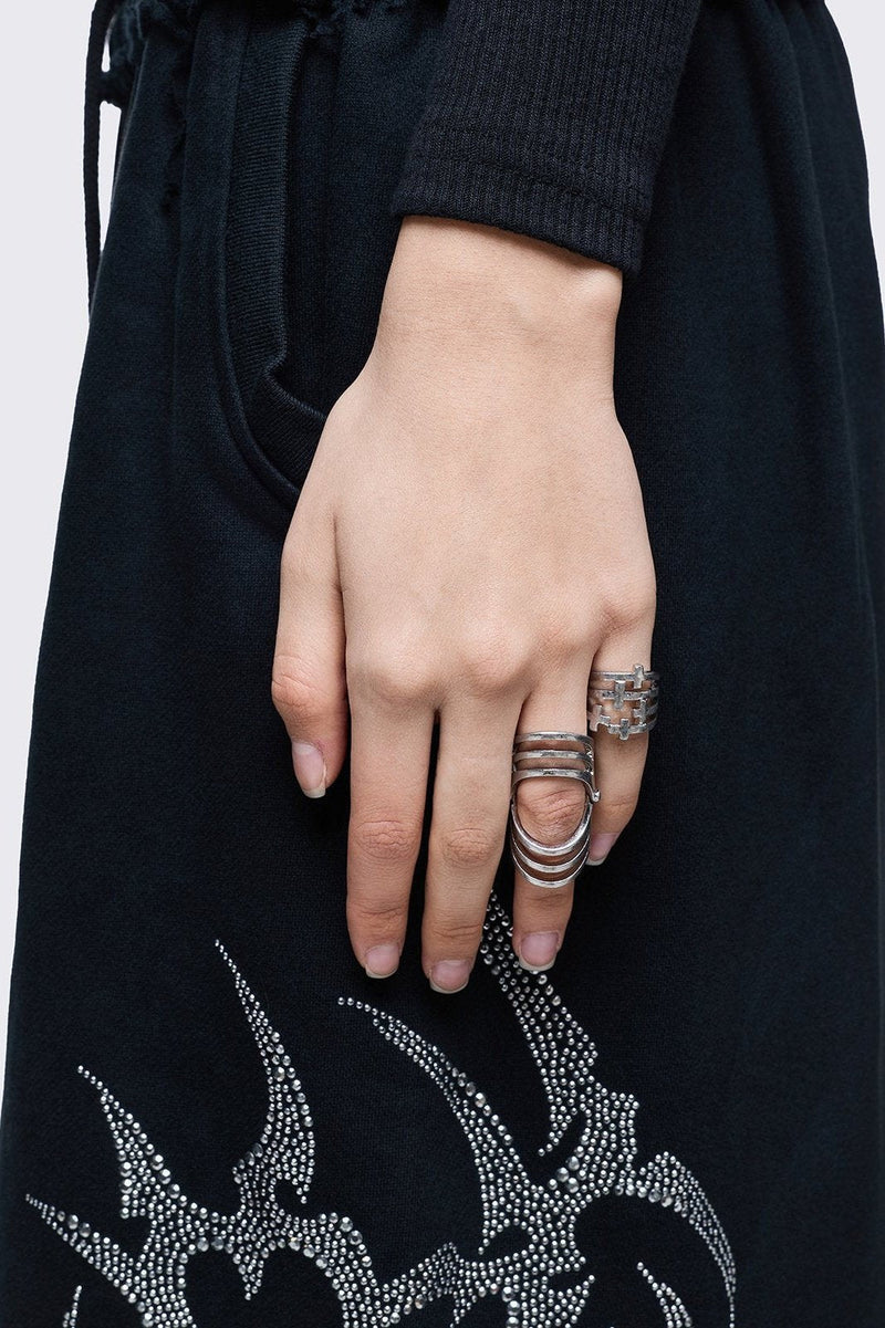 Silver set of 4 rings with cross designs.