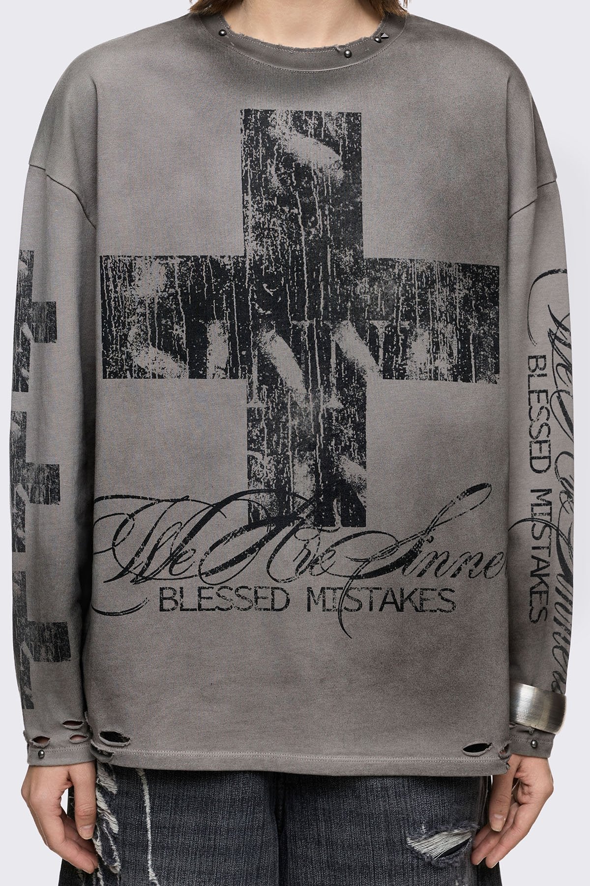 Grey cotton long sleeve T-shirt with cross graphic, studs and distressed hem in a grunge goth style.