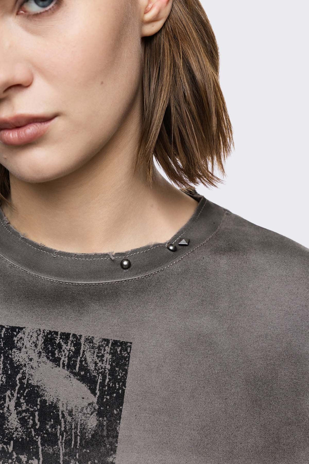 Grey cotton long sleeve T-shirt with cross graphic, studs and distressed hem in a grunge goth style.