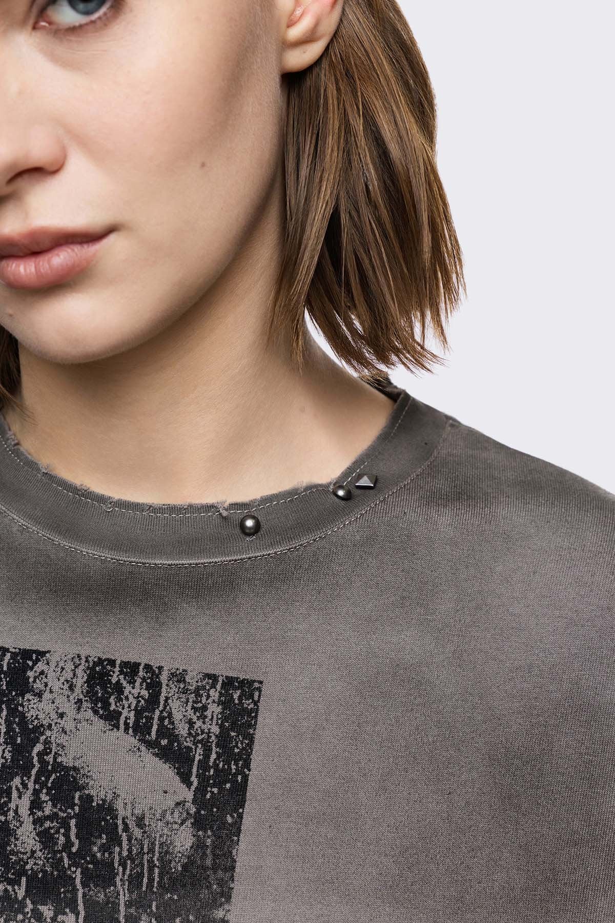 Grey cotton long sleeve T-shirt with cross graphic, studs and distressed hem in a grunge goth style.