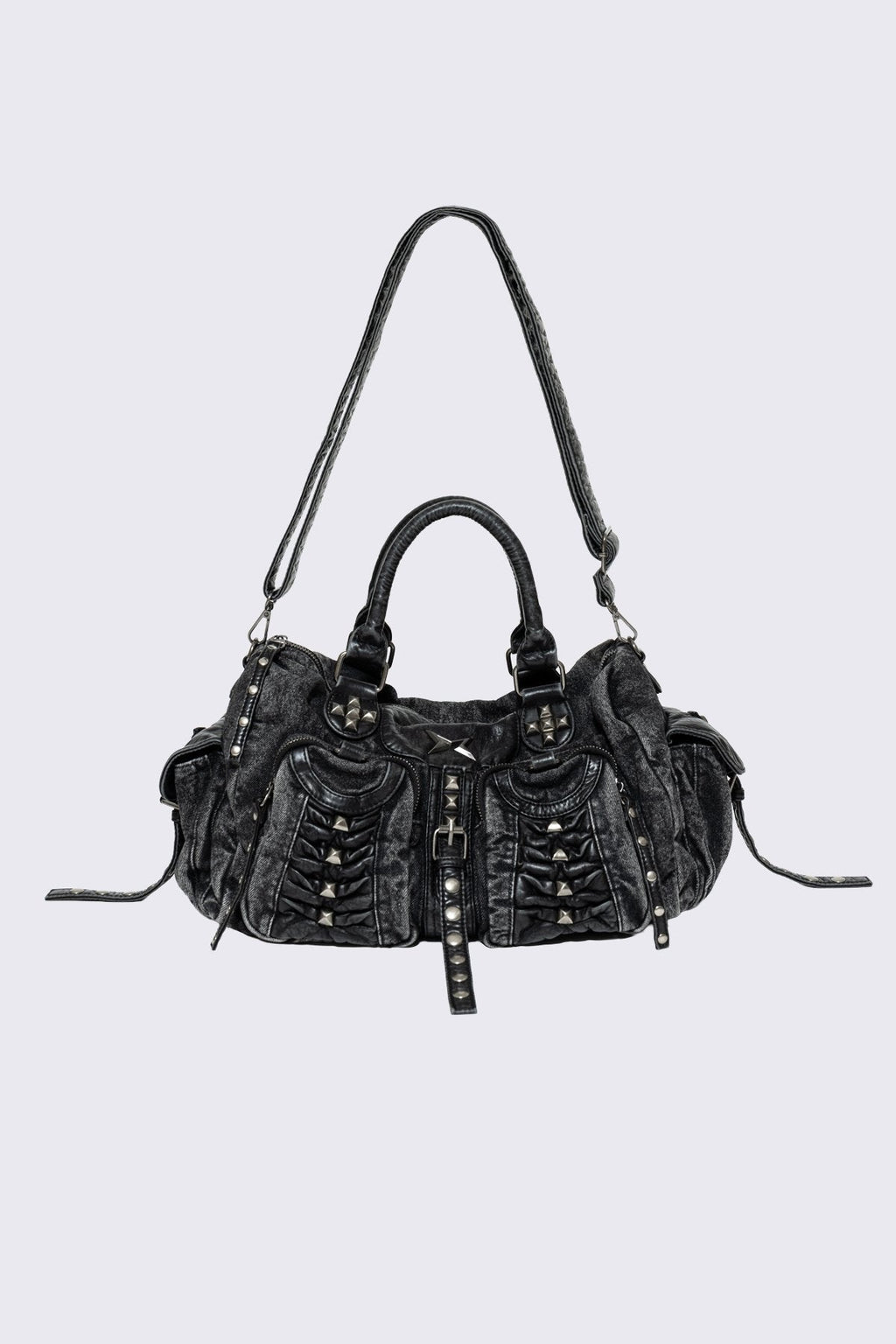 Black acid-wash denim shoulder bag with studs, ruched pockets and buckle details in a grunge Y2K style.