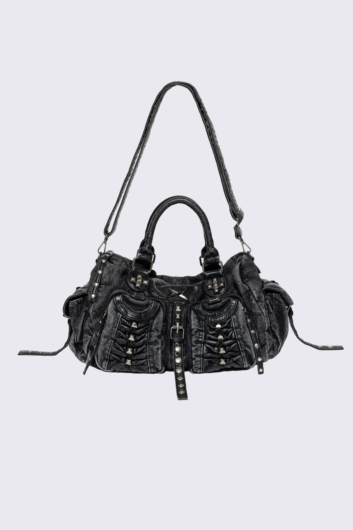 Black acid-wash denim shoulder bag with studs, ruched pockets and buckle details in a grunge Y2K style.